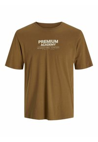 Brun bomulds t-shirt med korte ærmer og rund halsudskæring. Har hvid tekst "PREMIUM ACADEMY" og slogan nedenfor på forsiden.