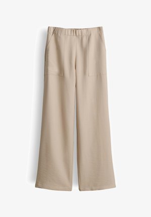 Beige wijde broek met elastische tailleband en voorzakken, gemaakt van zachte, lichte stof.