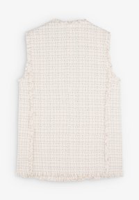 Mouwloze lichtroze vest met een gestructureerde, geweven afwerking, voorzien van franjes aan de randen en een ruitpatroon over het geheel.