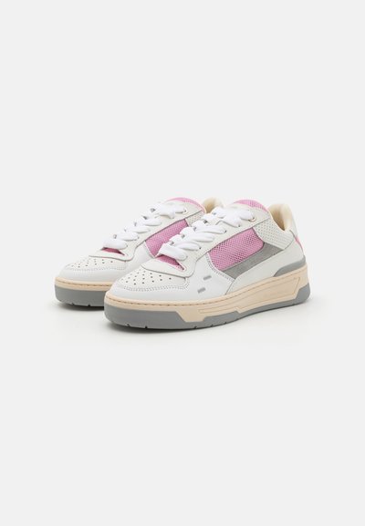 White sneakers featuring pink mesh panels, gray accents, and a textured sole. Lace-up design with perforations on the toe cap.