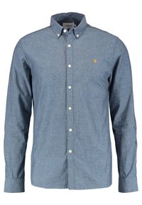 Niebieska koszula z długim rękawem zapinana na guziki, z kołnierzykiem zapinanym na guziki oraz małym żółtym wyszywanym logo "F" na lewej piersi.