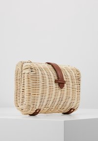 Woven straw crossbody bag with a rectangular shape, brown leather strap, and flat base. Textured finish with light beige tones.
