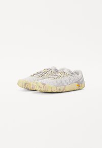 Baskets légères gris clair avec une tige en mesh texturé, semelle en caoutchouc jaune à motif contrastant et lacets gris ; conçues pour le confort et la respirabilité.