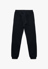 Sorte, tapered sweatpants med elastisk waistband og ribbede manchetter. Lavet af blødt stof med en glat tekstur. Ingen mønstre eller logoer synlige.