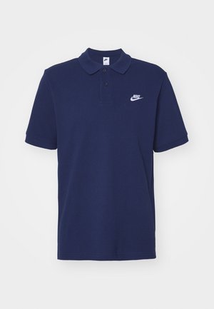 Navy blue polo shirt made of cotton, featuring a collar, two buttons, and a white Nike logo on the left chest. Short sleeves, smooth texture.