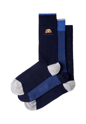 Three pairs of men's navy blue dress socks with grey toes and heels; one pair has a crest and "Hackett" logo, one has blue stripes, and one has a dotted pattern.