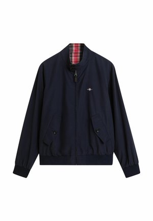 Chaqueta bomber azul marina con cremallera en el frente, dos bolsillos con botón y forro de cuadros. Presenta un dobladillo y puños elásticos para un ajuste ceñido.