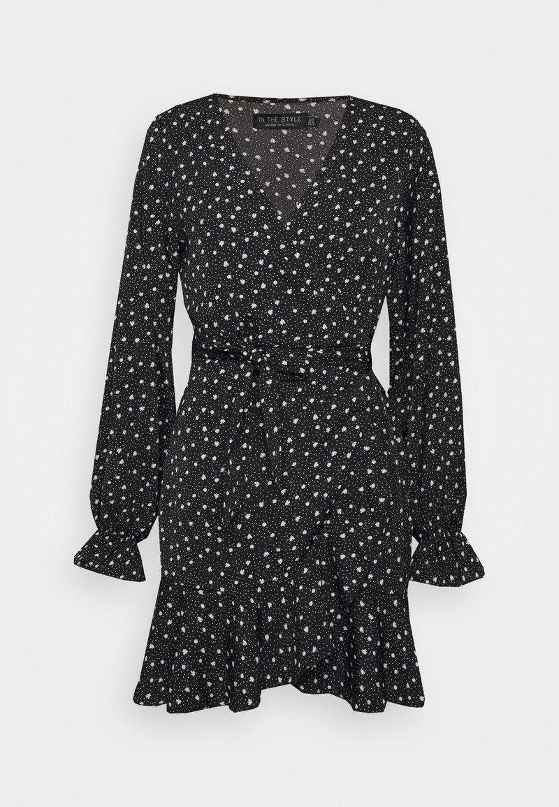 Robe portefeuille noire à manches longues avec imprimé floral blanc dispersé, taille nouée, encolure en V et ourlet et poignets à volants.
