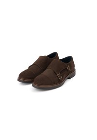 Brązowe zamszowe buty monk strap z okrągłym noskiem, podwójnym zapięciem na klamry i gładką skórzaną podeszwą.