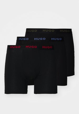 Három pár férfi fekete boxer alsónadrág, rugalmas derékpánttal. Minden pár ellentétes színű logó szöveggel rendelkezik: piros, kék és zöld.