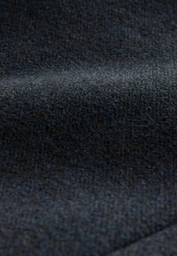 Gestructureerde donkergrijze stof met een zachte, vlezige uitstraling, met subtiele blauwe ondertonen en een geweven afwerking.