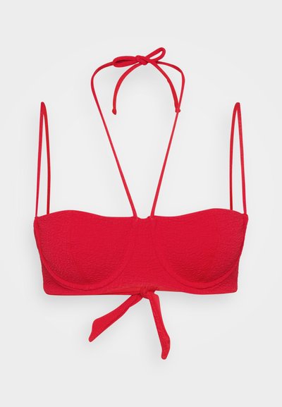 Red bandeau bikini top with textured fabric, adjustable ties at the neckline and back, and molded cups for support.