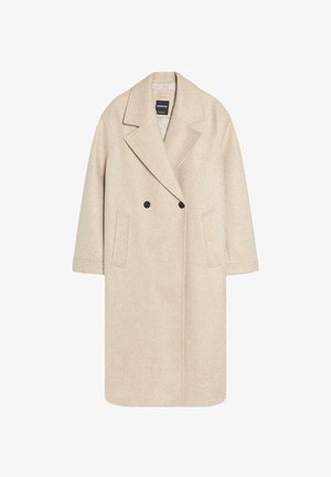 Lang beige uldblandet dobbeltknotret frakke med brede revers, to sidelommer og sorte knapper, vist på en hvid baggrund.