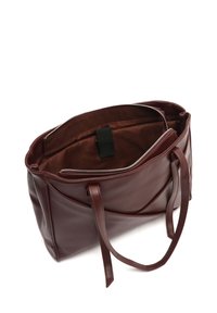 Burgundy leather tote bag with dual handles, zip closure, and an interior pocket; smooth texture and geometric panel design.