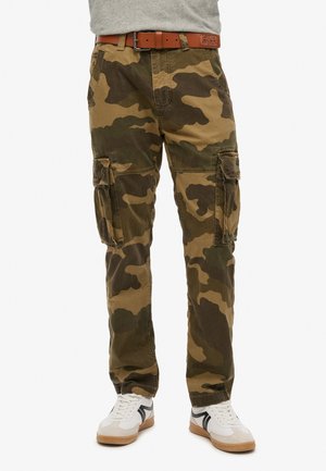 Camo cargo pants in shades of green and brown, made from durable fabric, featuring multiple side pockets and a relaxed fit.
