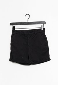 Shorts en coton noir avec une taille standard, poches avant et ourlets roulés. Caractéristiques d'une texture lisse et d'un design minimal.