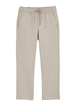 Beige afslappede bukser med elastisk talje og snøre, sidelommer, lige ben og synlige syninger på ensfarvet baggrund.