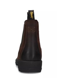 Botte en cuir marron vue de l'arrière avec des coutures visibles, une semelle épaisse noire et une languette de tirage noire portant l'inscription "Jeep" en texte jaune.