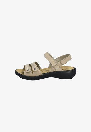 Beige sandalen met twee verstelbare banden, vierkante accenten, een gevoerd voetbed en een gevormde zwarte zool. Zacht, suède-achtig materiaal.