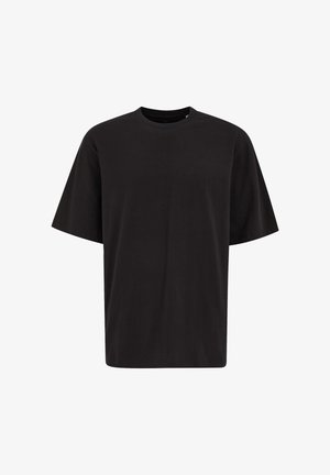 Camiseta negra de manga corta con cuello redondo, ajuste relajado y diseño liso, mostrada sobre un fondo blanco.