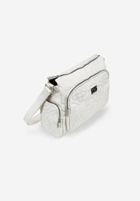 Bolso de hombro blanco acolchado con dos compartimentos con cremallera, correa ajustable y un acento metálico del logo en la parte frontal. Textura de tela suave.