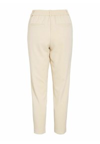 Beige, taps toelopende broek van een gestructureerde stof, met elastische tailleband en twee achterzakken. Soepele, lichte materialen met een minimalistisch ontwerp.