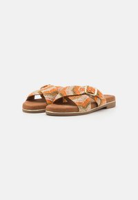 Braided slide sandals with orange and beige woven textile upper, brown suede footbed, and gold buckle detail; flat sole.