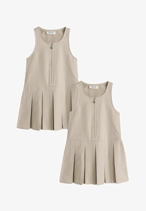Vestidos beige sin mangas con faldas plisadas y cremalleras delanteras con tiradores en forma de corazón, expuestos uno al lado del otro.