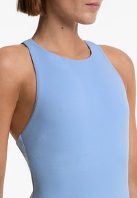 Light blue sleeveless bodysuit made of textured fabric, featuring a high neckline and athletic fit, with subtle side seam detailing.