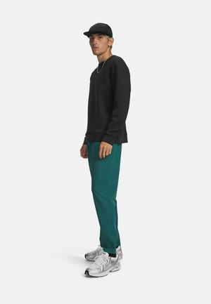 UA UNSTOPPABLE TAPERED - Jogginghose - rack green