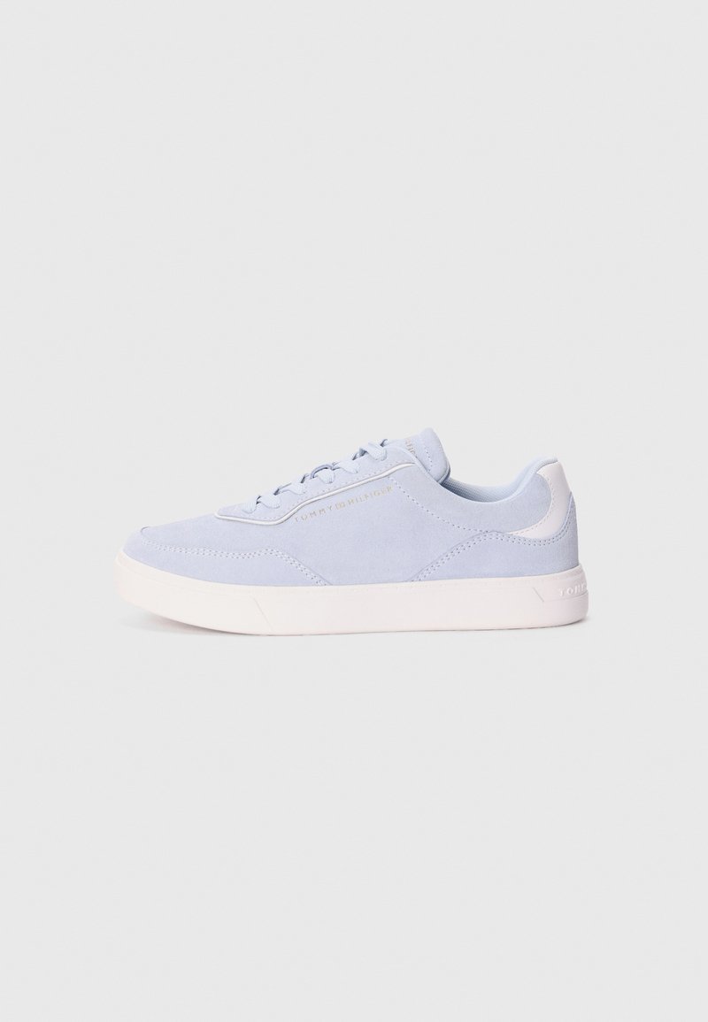 Light blue suede sneaker with a white rubber sole, featuring round laces and a small logo detail on the side. Smooth texture overall.