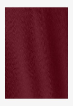 Deep red fabric with subtle vertical wrinkles and a soft, slightly textured surface.