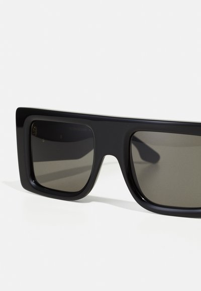 Black square sunglasses with thick frames, dark tinted lenses, smooth texture, and a minimalist design. No visible logos or additional accents.