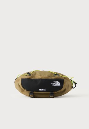 Khaki en zwarte The North Face heuptas met ritsvak, twee clips, neon gele accenten en "TERRA" bedrukt op de voorkant.