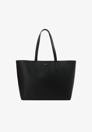 Black leather tote bag with two handles, minimalistic design, smooth texture, and a gold logo detail on the front.