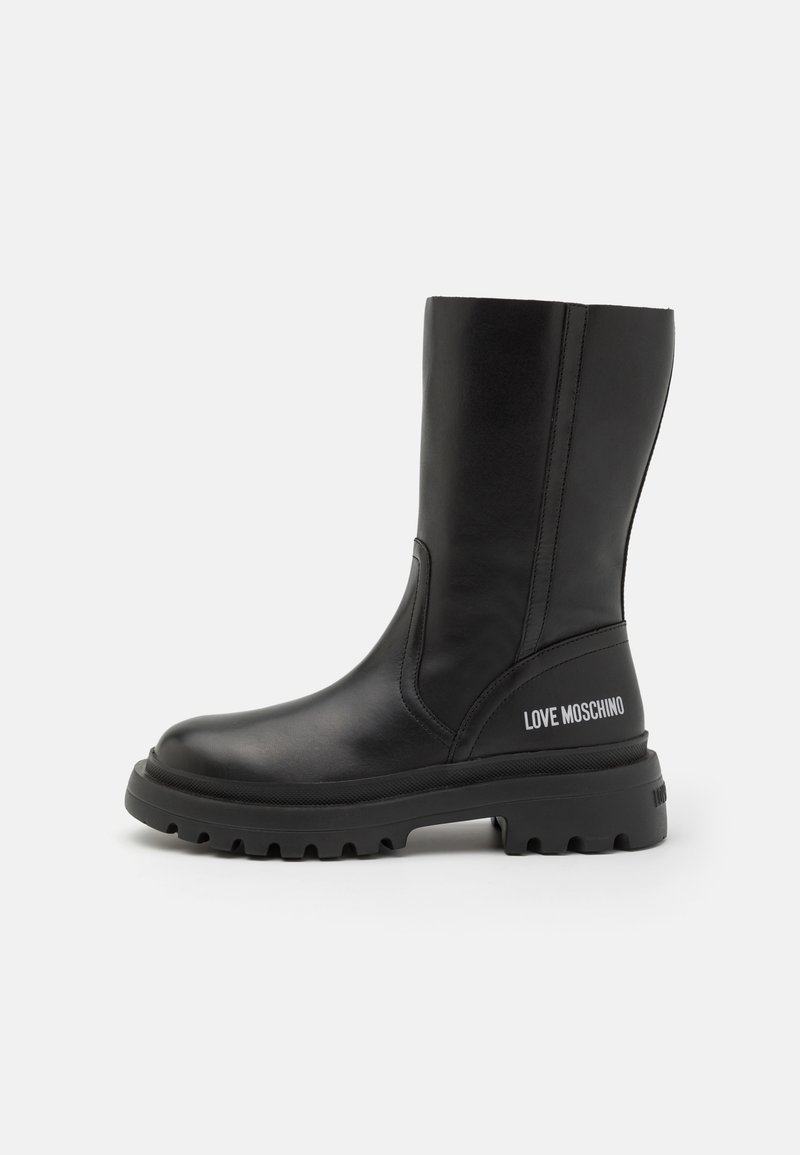 Black leather knee-high boots with a round toe, rubber sole, and embossed "LOVE MOSCHINO" text on the outer side. Smooth texture.