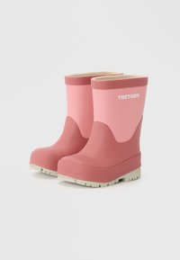 Stivali da pioggia in gomma rosa con una superficie testurizzata, dettagli beige e un design a profilo basso. Presentano un logo sul lato.