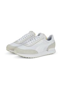 White athletic shoes with a mix of smooth synthetic and soft suede materials. Features a padded collar, textured sole, and subtle branding details.