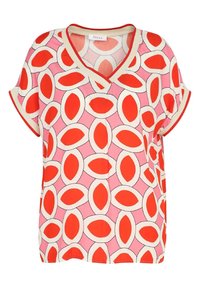 Kortærmet V-hals top i pink med et dristigt rødt og hvidt mønster af ovale former; blødt stof med kontrastfarve ved halsudskæringen og ærmekanterne.