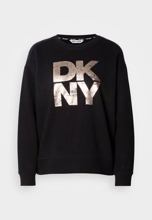 Black sweatshirt featuring a large, distressed metallic gold "DKNY" logo. Long sleeves and ribbed cuffs with a relaxed fit design.