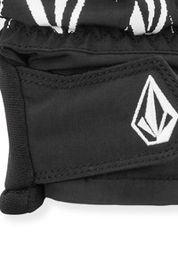 Gant en tissu noir avec poignet élastique, présentant un logo blanc et des accents cousus, conçu pour la prise en main et la protection, surface texturée.