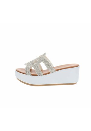 Sandalo platform con zeppa bianca, soletta color cuoio e cinturini con strass scintillanti che formano un motivo traforato sulla parte superiore.