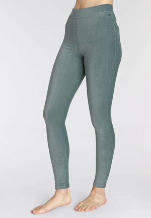 Hochtaillierte Leggings aus einem strukturierten, tealgrünen Stoff. Sie verfügen über ein enges Design mit sichtbaren Nahtnähten und einem glatten Bund.