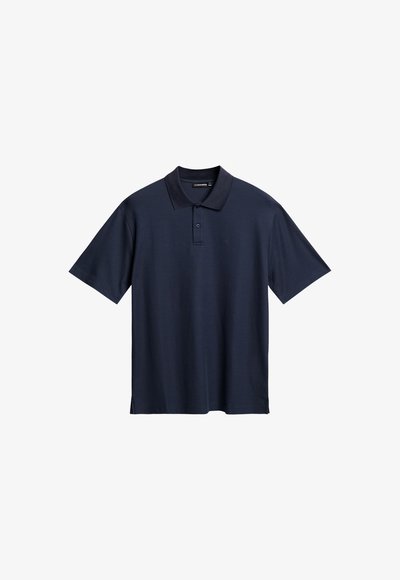 Marinblå kortärmad pikétröja i mjuk bomull. Har en klassisk krage, knapplist med tre knappar och sidofickor för bättre rörelsefrihet.