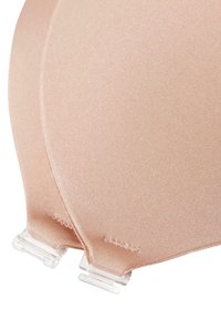Bra with soft, padded cups in a light beige color, featuring smooth fabric texture and clear plastic hardware for adjustable straps.