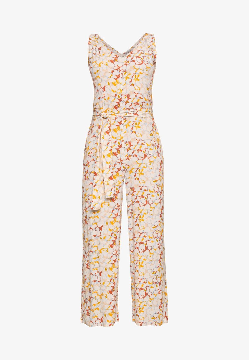 Combinaison fleurie blanche, avec un décolleté en V, sans manches, taille ceinturée et jambes larges ornées de motifs jaunes, rouges et verts.