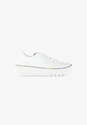 White sneakers with a textured rubber sole, featuring a layered design and a multicolored stitched accent around the midsole.
