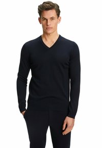 Marineblaue V-Ausschnitt-Strickjacke aus weichem Strickstoff mit langen Ärmeln und gerippten Bündchen. Schmale Passform mit einem klaren, minimalistischen Design.