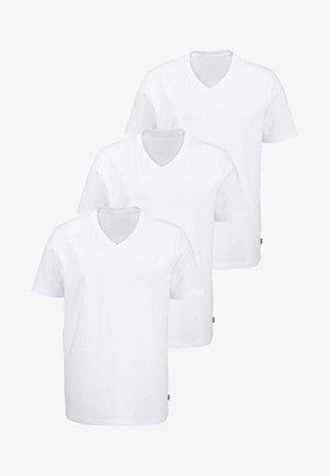 Three white cotton t-shirts with short sleeves and v-neck design. Each has a straight hem and a small red accent tag on the lower left side.