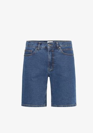 Tumedates sinises klassikalise lõikega teksapüksid. Omavad esi-taskuid, nööbikinnitust ja diskreetset õmblust mööda õmblusi.